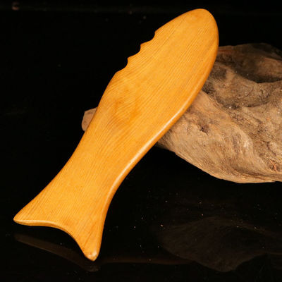 Gele hout gua sha bord voor de traditionele Chinese geneeskunde