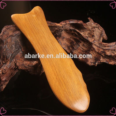 Gele hout gua sha bord voor de traditionele Chinese geneeskunde