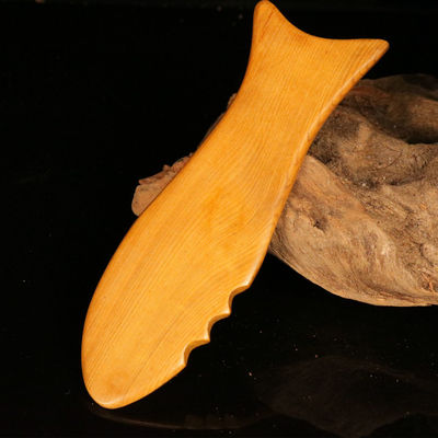 Gele hout gua sha bord voor de traditionele Chinese geneeskunde