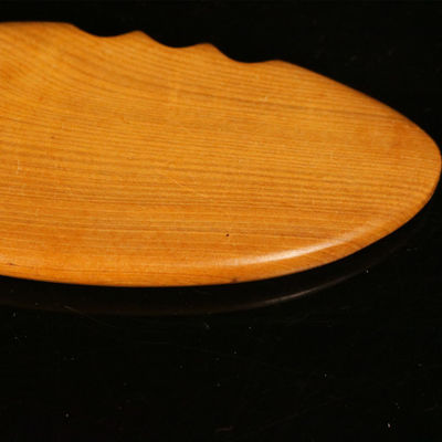 Gele hout gua sha bord voor de traditionele Chinese geneeskunde